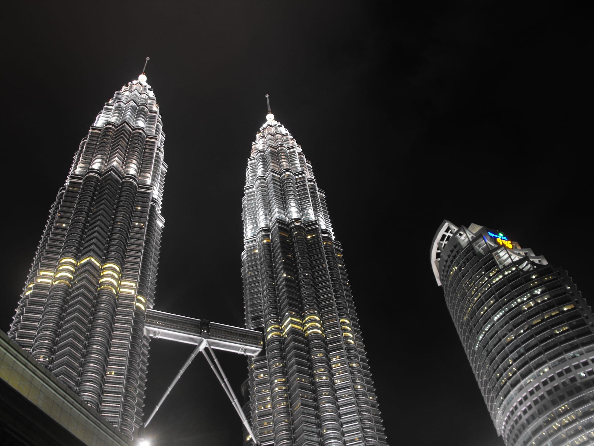 The Petronas Twin Towers lit up against the evening sky in Kuala Lumpur